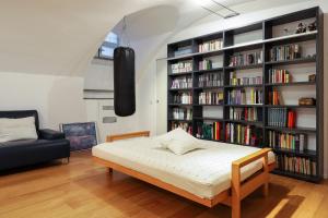 a bedroom with a bed and a book shelf with books at Luxury Loft in Milan