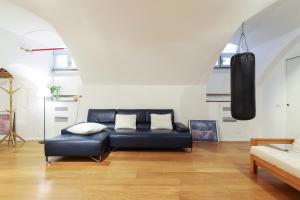 a living room with a black leather couch in a room at Luxury Loft in Milan