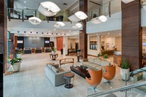 a lobby with couches and chairs in a building at Comfort Suítes Vitória in Vitória +37 photos