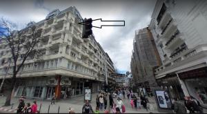 a traffic light on a busy city street with buildings at Naumovski Apartments in Skopje +5 photos