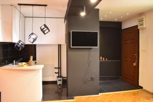 a kitchen with a flat screen tv on the wall at Naumovski Apartments in Skopje