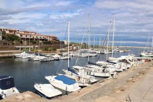 a bunch of boats are docked in a marina at 103 Boutique Hotel Stintino in Stintino