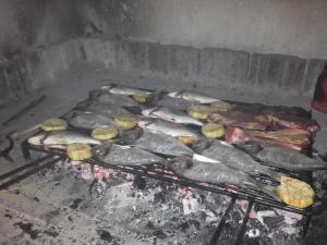 a bunch of fish and potatoes on a grill at Apartment Josip II in Ston