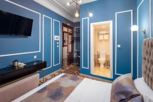 a blue room with a toilet and a television at Casa De La Sera in Rhodes Town