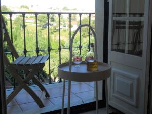 a table with a glass of water and a glass of wine at Galo Preto - Urban Agriculture - Healthy Food in Sintra