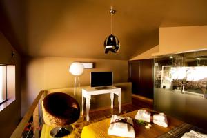 a living room with a chair and a desk with a computer at RH Casas de Campo Design in Parada