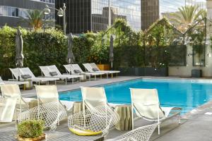 a group of chairs and a swimming pool at The LINE Hotel LA in Los Angeles