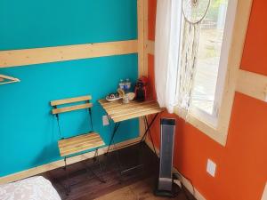 a corner of a room with a blue wall and a window at New Buddha Bing Unique Experience Cottage and Cabins in Tobermory
