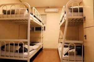 a room with bunk beds in a dorm room at Busan Sukbak Dot Com Guesthouse in Busan