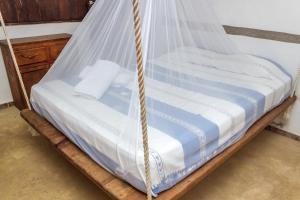 a bed with a net on top of it at Cabañas Biuzaa in Zipolite +31 photos