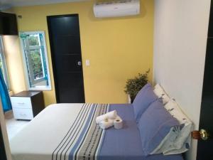 a bedroom with a bed with two stuffed animals on it at Hotel Español Neiva in Neiva