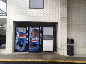 a building with two vending machines on the side of it at Royal Inn Columbia/Fort Jackson in Columbia