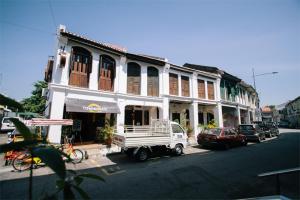 a white truck parked in front of a building at Boutique Guest House in George Town