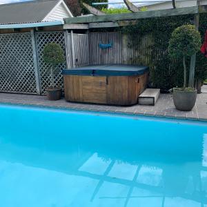 a hot tub sitting next to a swimming pool at Hawkes Bay Villa-Beechwood in Hastings