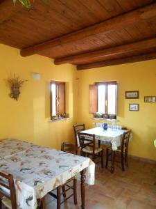 a dining room with two tables and chairs at Azienda Agrituristica Risveglio Naturale in Varese Ligure