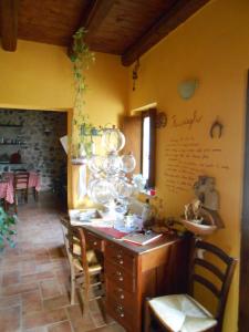 a room with a counter with chairs and a table at Azienda Agrituristica Risveglio Naturale in Varese Ligure