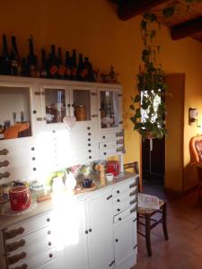 a room with a large white cabinet with a table at Azienda Agrituristica Risveglio Naturale in Varese Ligure