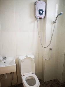 a small bathroom with a toilet and a shower at Cozy 3 Bedrooms Apartment Langkawi in Kuah