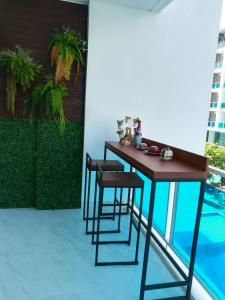 a table and chairs on a balcony with a pool at My Resort Hua Hin E306 in Hua Hin