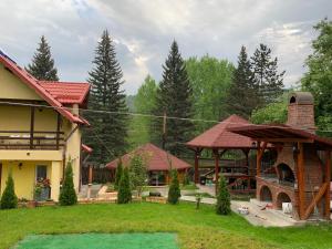 a group of houses with trees in the background at Casa Galbena in Slănic