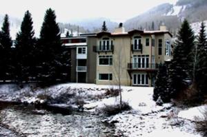 a large house with snow in front of it at House Steps to Gondola and Vail Village in Vail