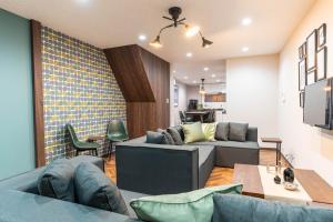 a living room with two couches and a table at Harbor Light Tengachaya in Osaka