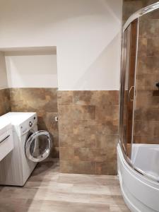 a bathroom with a washing machine and a shower at Próchnika 49 Rooms in Łódź +77 photos