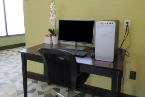 a computer sitting on a desk with a chair at Quality Inn Longmont in Longmont