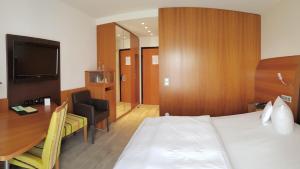 Postel nebo postele na pokoji v ubytování Astralis Hotel Domizil