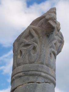 a statue of a head on top of a building at Roses Studios in Karpathos