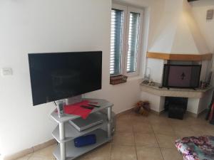 a computer monitor on a stand in a room at Villa Lora in Tučepi