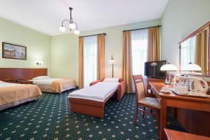 Posteľ alebo postele v izbe v ubytovaní Hotel Hetman + 21 fotografií
