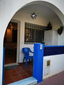 a blue chair sitting in front of a house at Apartamento la Isletilla in Almería