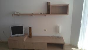 a tv sitting on top of a wooden cabinet at MARINA REZIDENCE *** in Kavarna