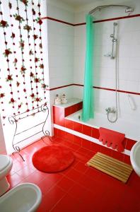 a bathroom with a shower and a red tiled floor at 5 Balconi B&B in Catania