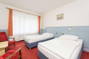 Ένα ή περισσότερα κρεβάτια σε δωμάτιο στο Sport Hotel Gejzirpark