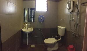a bathroom with a toilet and a sink at UK FARM Agro Resort in Kluang