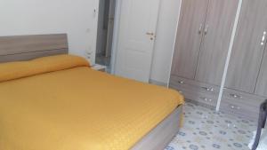 a bedroom with a bed and a dresser at Holidays Baia D'Amalfi in Amalfi