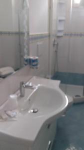 a bathroom with a sink, toilet and bathtub at Holidays Baia D'Amalfi in Amalfi