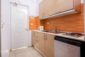 a kitchen with a sink and a stove at Yianna Studios in Faliraki