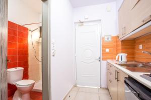 a small bathroom with a toilet and a sink at Yianna Studios in Faliraki +47 photos