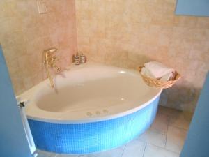 a bathroom with a tub with a basket of towels at Azienda Agrituristica Risveglio Naturale in Varese Ligure +71 photos