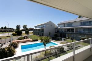 a view from the balcony of a apartment building with a swimming pool at Lake Terrace Apartment in Taupo