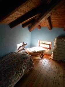 a bedroom with a bed and a wooden floor at Azienda Agrituristica Risveglio Naturale in Varese Ligure