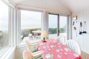 a dining room with a table and chairs and windows at 2 Bed 1 Bath Vacation home in Eastham in Eastham