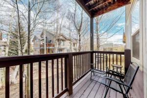 a porch with a chair and a view of a house at Tarn Landing B7 in Frisco