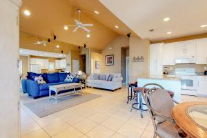 a living room with a blue couch and a kitchen at 2 Bed 2 Bath Vacation home in Destin in Destin