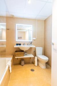 a bathroom with a sink and a toilet and a mirror at Trendy Homes Almería in Almería +11 photos