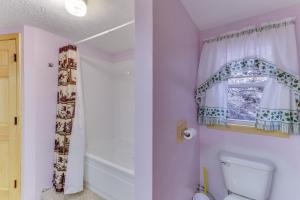 a bathroom with a toilet and a window at 4 Bed 2 Bath Vacation home in Whittier in Whittier +22 photos