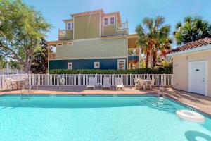 a house with a swimming pool in front of a house at 2 Bed 2 Bath Vacation home in Destin in Destin